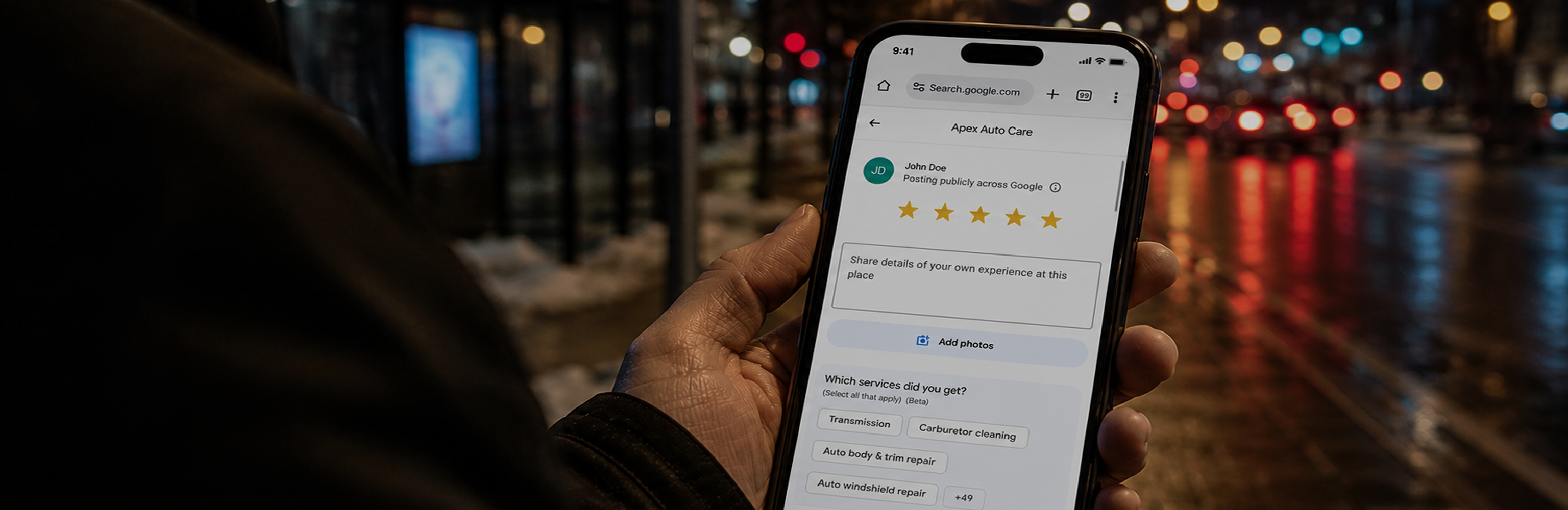 Person holding phone showing a Google review